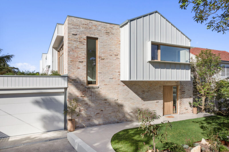 Exterior façade of modern home with turner oak malt uPVC double glazed windows and door.